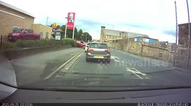 Dashcam captures driver crashing over wall of KFC in UK