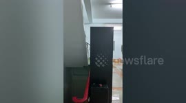 Rainwater cascades down steps like a waterfall after heavy rain in Thailand