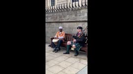 Bagpipe player and traditional African drummer make harmonious beat on Scottish street