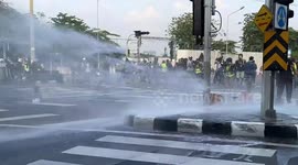 Riot police fire water cannon at protesters during clashes in Bangkok
