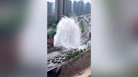 Free car wash! Motorists slow down as burst water main sprays highway traffic in China