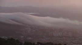 Watch this stunning time-lapse footage as fog rolls in from the hills, engulfing the city of Barcelona