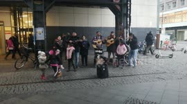 Berlin center. street musicians sing and play guitars very beautifully.
