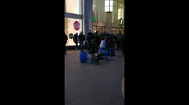 Berlin. A street musician plays drums made from old buckets.