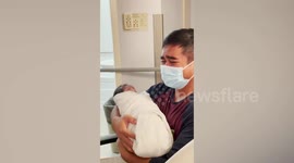 Father cries tears of joy while holding newborn baby for first time in Canada