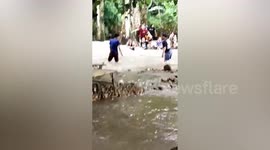 Brave locals rescue tourist stranded in raging floodwaters in Thailand