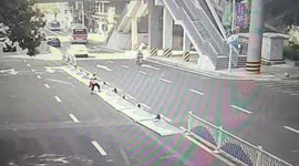 BETTER QUALITY VERSION: Elderly woman pulls down traffic barriers to take a shortcut in southern China