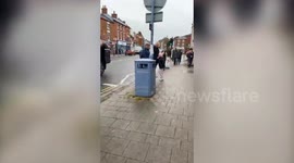 Shoppers form human chain to help store moving up the street