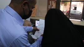 Palestinians wait to legalize their documents at Civil Affairs office.