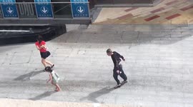 Pedestrians struggle to walk as strong winds from Typhoon Kompasu blast southern China