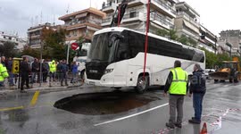 Coach tips into huge sinkhole as deadly storms lash Greece
