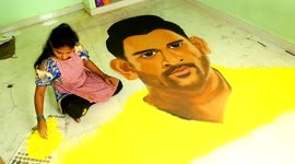 Girl draws Indian cricket star MS Dhoni out of coloured powder