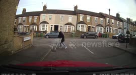 Lockdown madness-Young woman pushes a supermarket trolley, decides to stop against a wall, gets in it to listen to her music, has a ride up down the wall for few minutes then get out and walks off