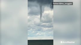 Bystander films waterspout funnel forming off Lake Erie shoreline