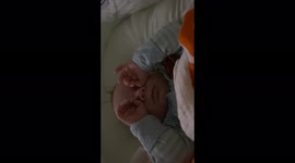 Baby boy sleeping with hand binoculars!