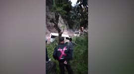 Landslide traps motorists after heavy rain in the Philippines