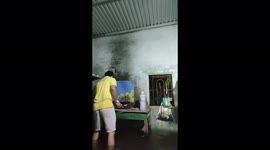 Flood water flooded the house while the man was cooking