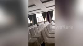Guest wanting to check weather finds large meeting room after opening curtains in Chinese hotel