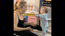 Baby stands up for first time and immediately bursts into adorable laughter