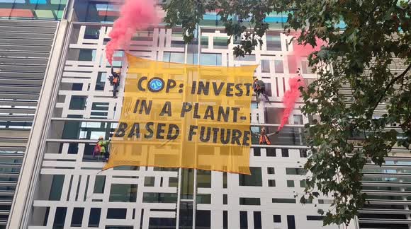 Climate activists scale Home Office building in London to call for 'plant-based future'