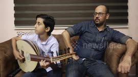 Palestinian boy Samih al Madhoun, 14, plays the oud and sings at his home