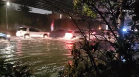 Cars drive through flooded roads in New York as powerful storm gathers