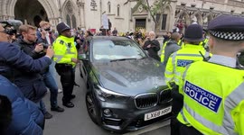 Julian Assange protesters stand in road outside Royal Courts of Justice Strand