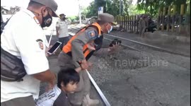 A very stubborn 6-year-old boy wants to play on the rubber rail in Jakarta Indonesia