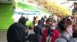 People waiting outside Stansted airport while suspicious package incident is being accessed