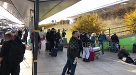 People waiting outside Stansted airport while suspicious package incident is being accessed