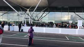 People waiting outside Stansted airport while suspicious package incident is being accessed