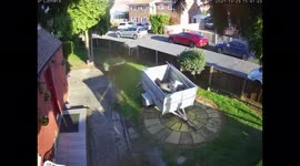 Hermes delivery driver lobbing parcel from the street at back door.