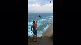 Aussies create 'natural boomerang' by throwing and catching sticks off cliff on windy day