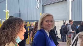 British Foreign Secretary Liz Truss surrounded by journalists at COP26