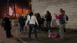 A group of protesters dance with Extinction Rebellion flags in front of COP26 venue as thousands of delegates leave the summit