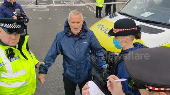 Insulate Britain protester arrested after glueing himself to police van in London