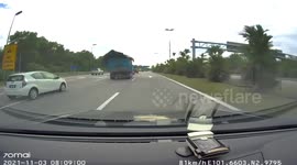 Motorcycle rider miraculously survives after lorry tarpaulin comes loose and knocks him into a fuel tanker