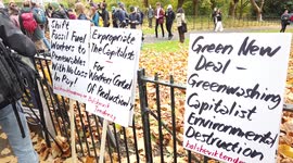 Three Protestor signs at COP26 Protests at Glasgow 2021 United Kingdom as Protestors Chant