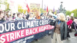 Large crowd of socialist protestors hold banners and signs and chant loudly at COP26 Protests at Glasgow 2021 United Kingdom