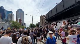 Protesters listen to the musician and applaud him, Melbourne, Australia