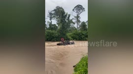 Firefighters rescue boy stranded on rock during floods in Malaysia