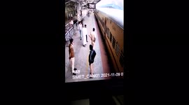 Dramatic moment railway cops save woman who fell from train