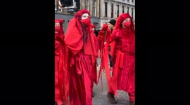 Colorful Extinction Rebellion protesters march through Glasgow, UK