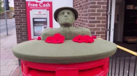 Knitted post box topper commemorates Remembrance Day, in Kent, UK