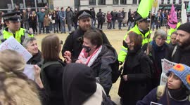 Police shove Extinction Rebellion protesters out of parade's path at Lord Mayor's Show in London