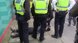 Police carry protesters off the road as Extinction Rebellion attempt to block Lord Mayor's Show parade