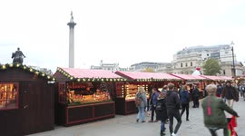 A row of stalls set up as Christmas market next to trafalgar square