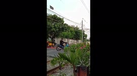 Motorcyclist Breaks Through the Fire Cross Railroad Tambora, West Jakarta, Indonesia