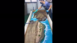 Watch these carpenters create a beautiful table with a desert island theme on top