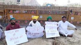 Farmers sitting while displaying the Playcard demand to withdraw the MSP during their ongoing Protest at Ghazipur,Delhi.